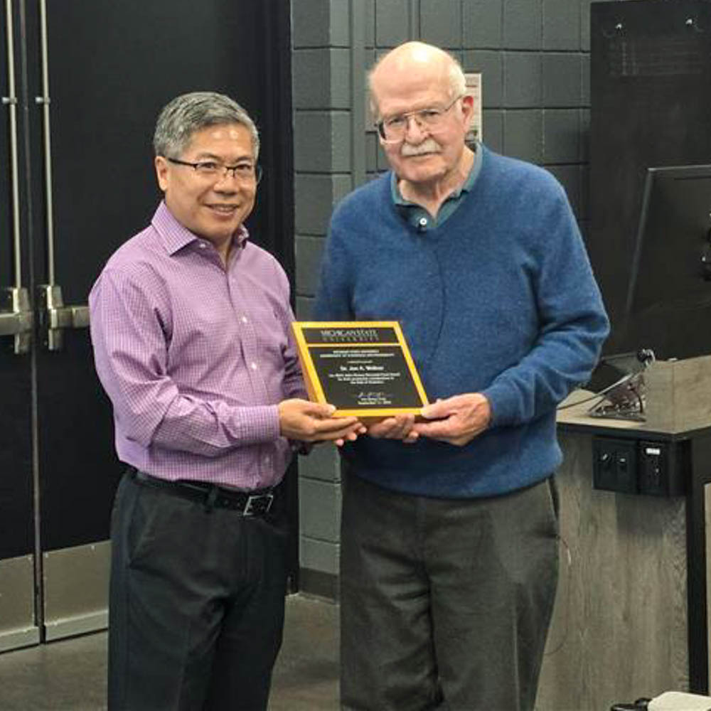 Hao Zhang, Chair of the Department of Statistics and Probability presenting a plaque to Dr. Jon Wellner.